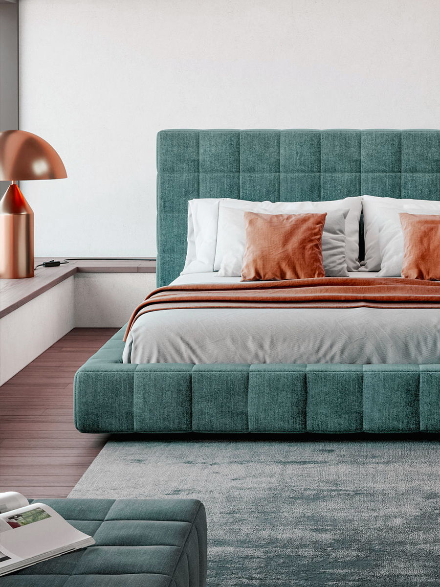 Modern bedroom with teal Squaring bed by Bonaldo, decorative pillows, and a stylish lamp.