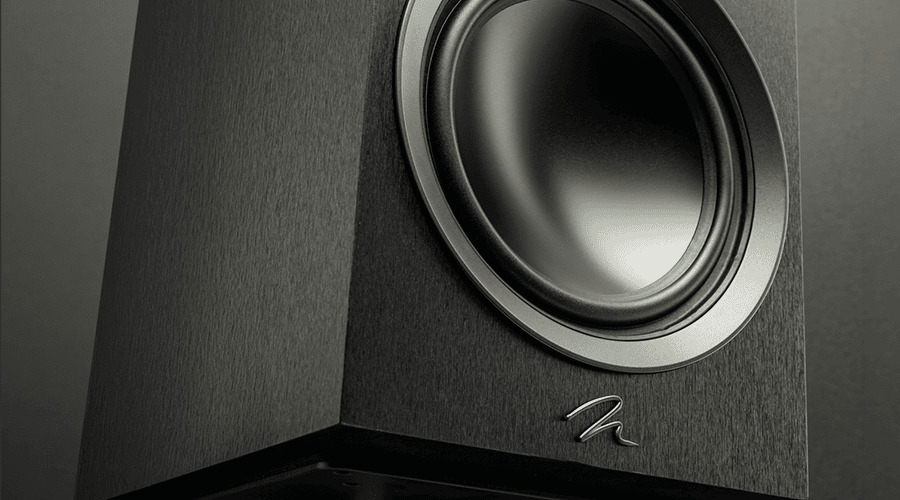 Close-up of a black speaker with a prominent woofer.