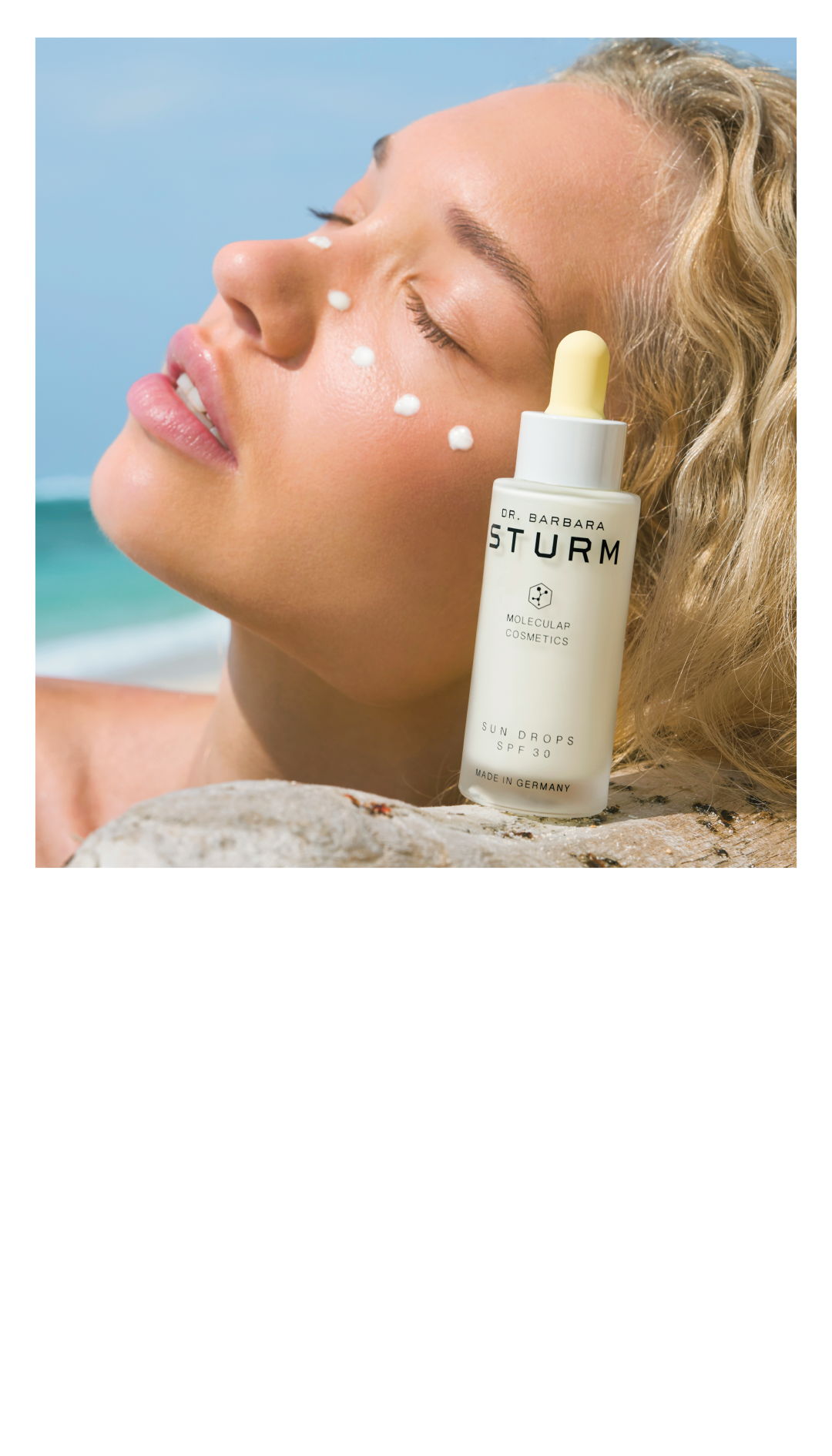 Woman applying skincare product by the beach.