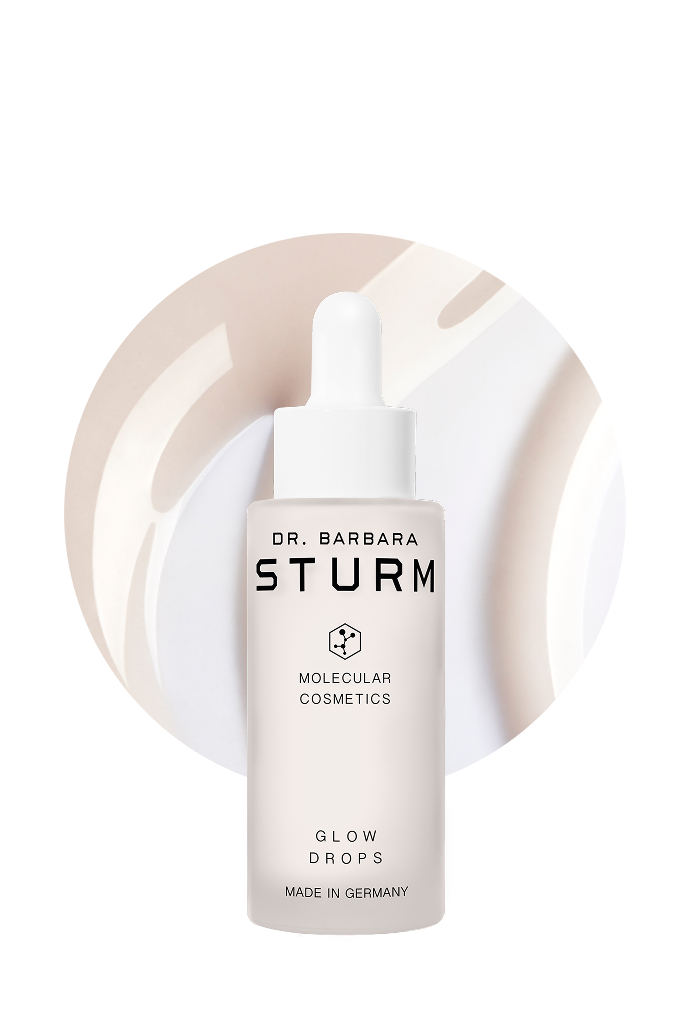Bottle of Dr. Barbara Sturm Glow Drops on a circular background.