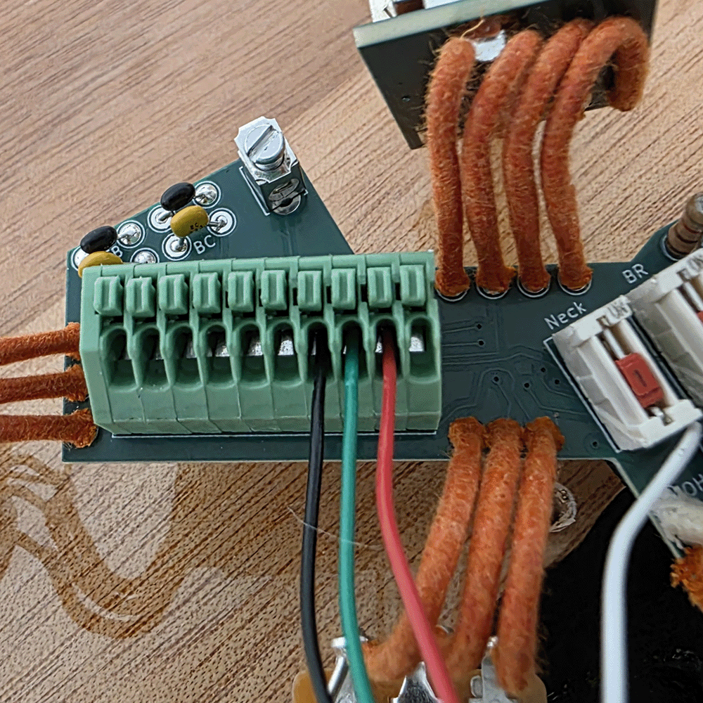 Close-up of a circuit board with connected wires and terminals.