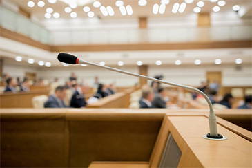 Council chamber with gooseneck microphones and a dais