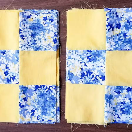 two piles of quilt blocks ready to be assembled into a quilt top