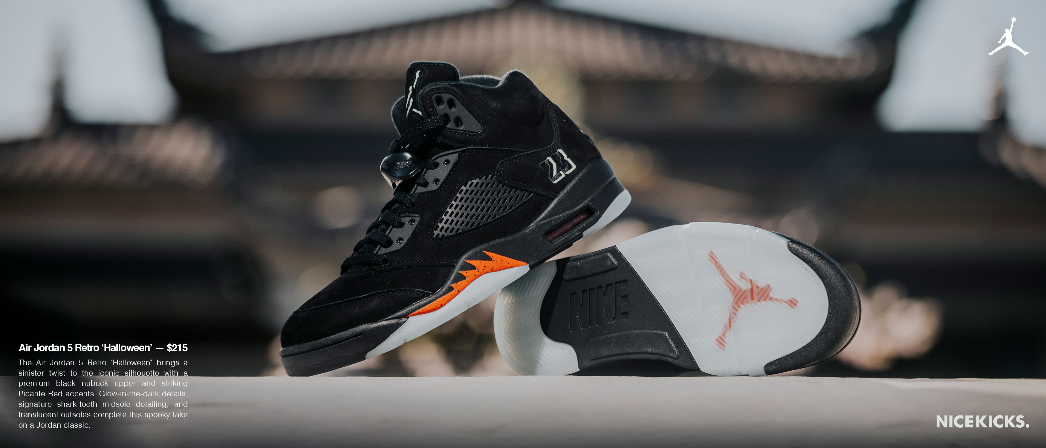 A pair of black and orange Air Jordan sneakers displayed creatively.