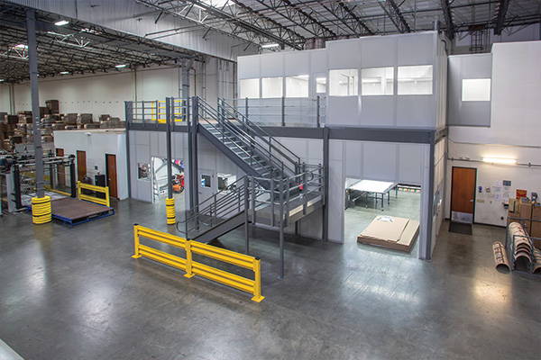 Two-story mezzanine installed with inplant offices in industrial setting.