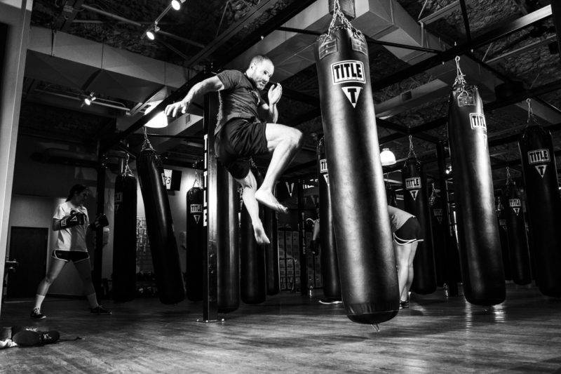 Man Kicking A Punching Bag