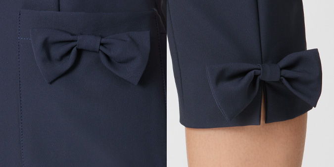 Close-up of navy sleeves with decorative bows.