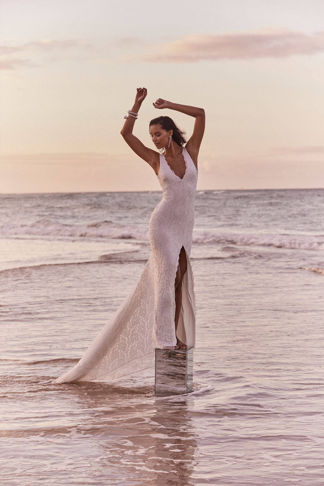 Campaign imagery of model in Lumi gown on the beach