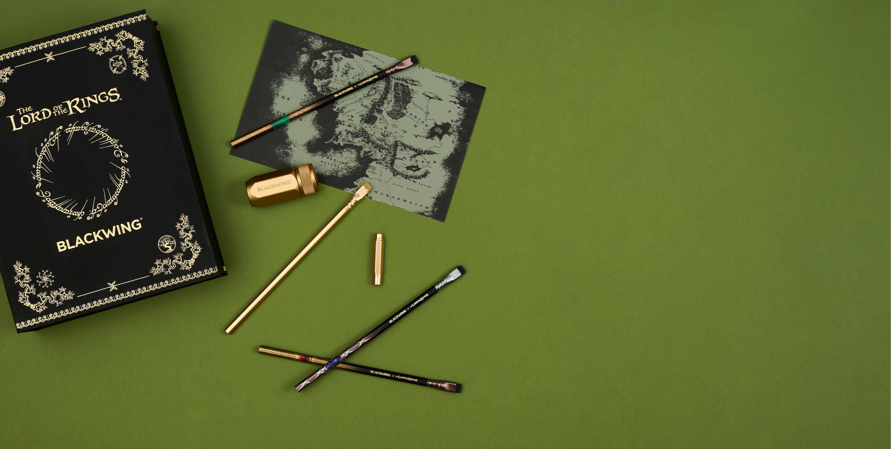 Blackwing x LOTR set with pencils, sharpener, and point guard and a map on a green background.