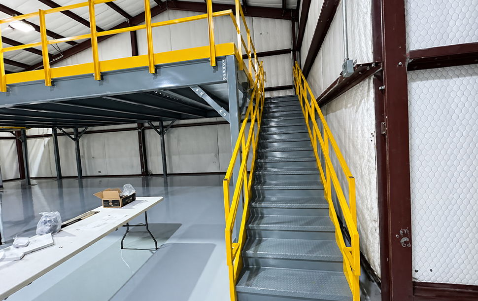 Stairs leading to a raised platform in an industrial setting.