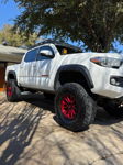 Low-angle white Tacoma red metallic wheels Terra Hunter tires tree shadows blue sky Joel's 2021 Tacoma 2-Chime 3-Liter gallery photo 3