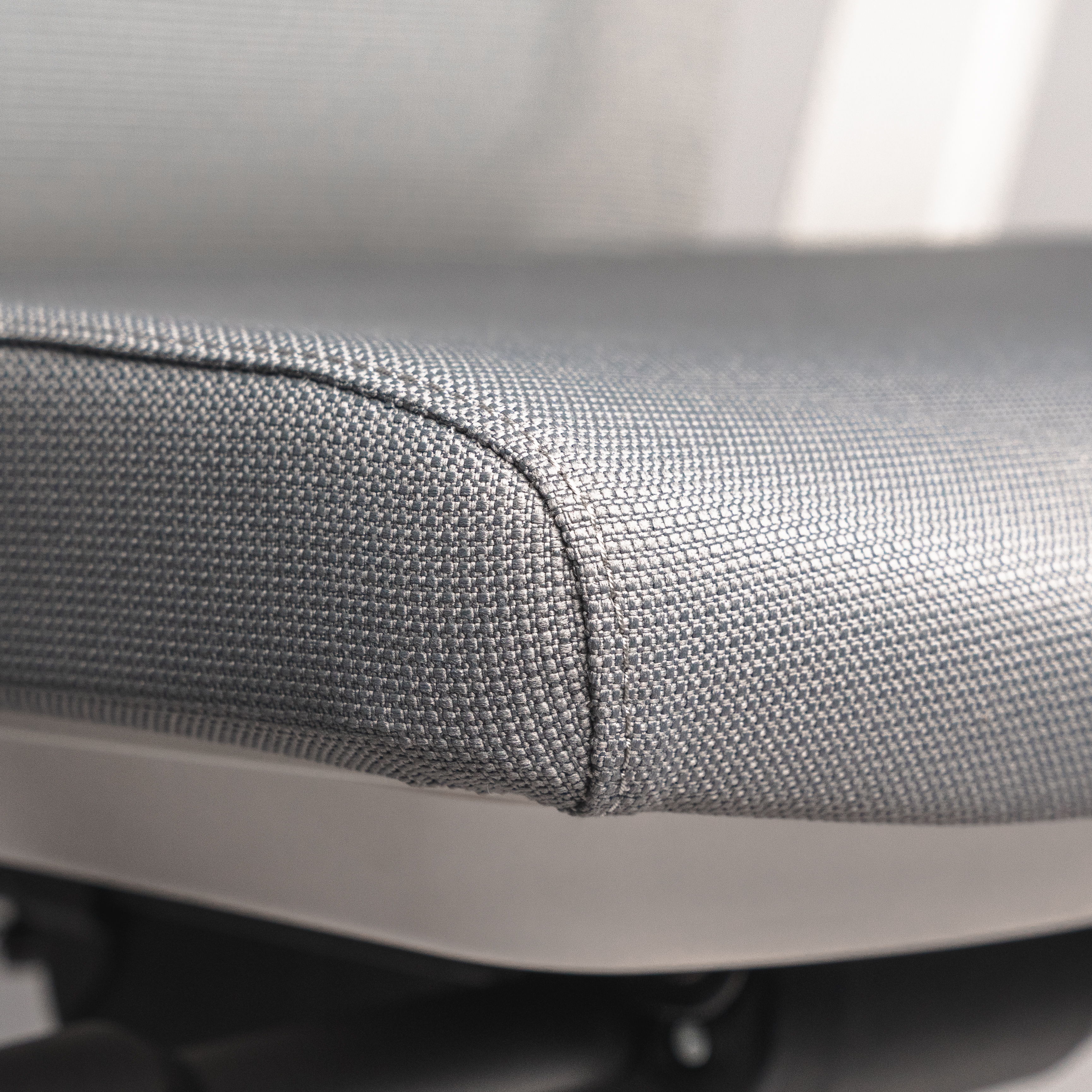 Close-up of the soft seat of the white, ergonomic " Active " office chair Active ofinto