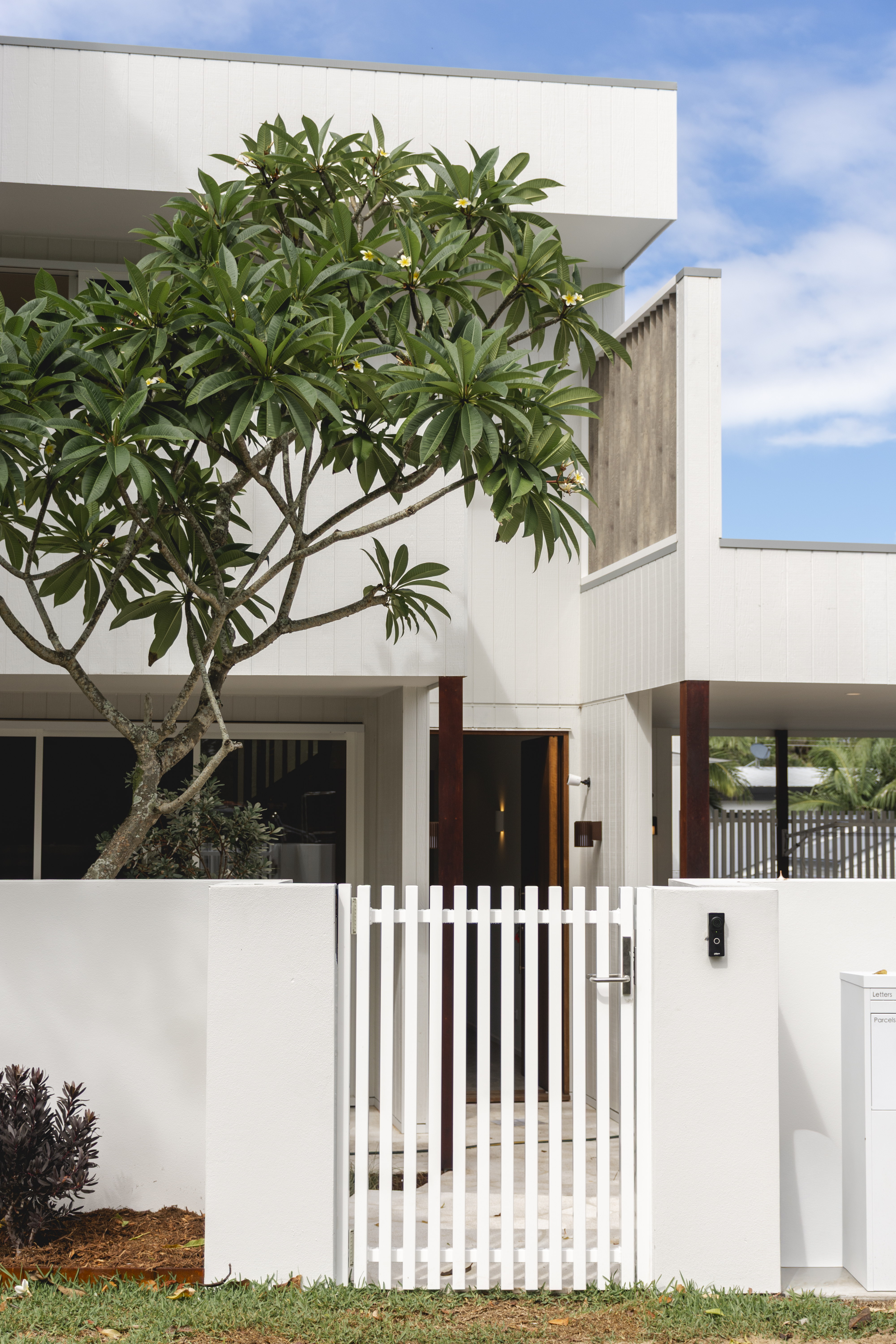 Ribbed Aluminium Cylindrical Wall light on a modern coastal house