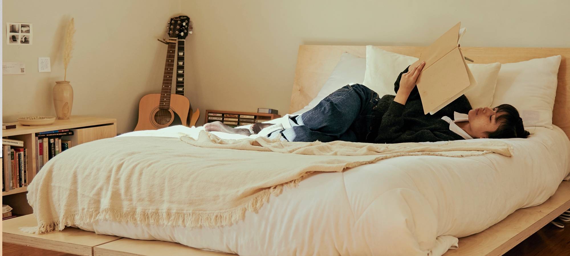 Laying on a full size birch plywood platform bed with headboard