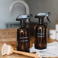 Spray bottles with homemade cleaning supplies on a counter