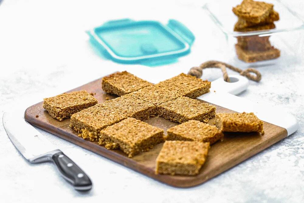 Flapjacks cut into squares on a chopping board.