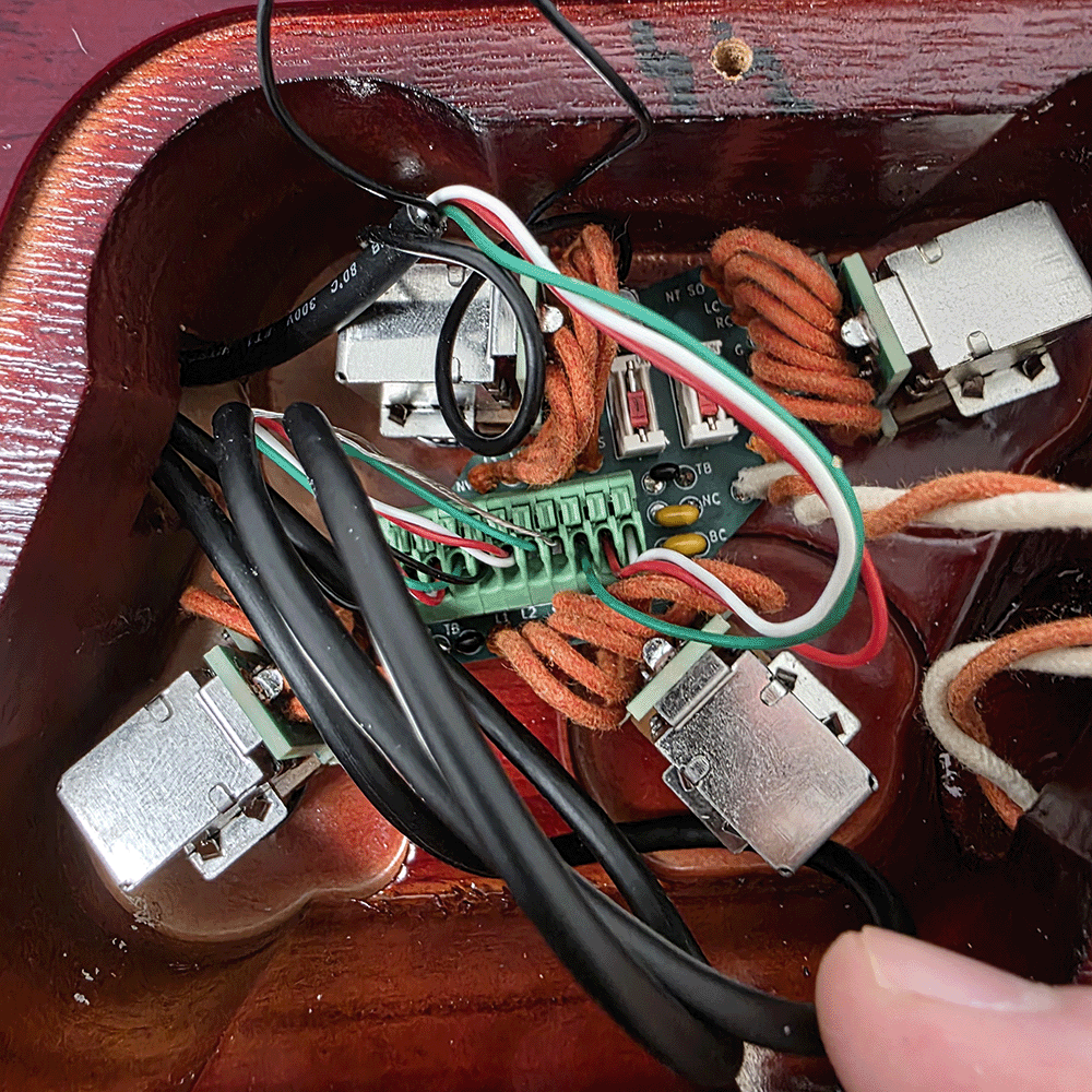 Wiring and connectors inside a wooden box.