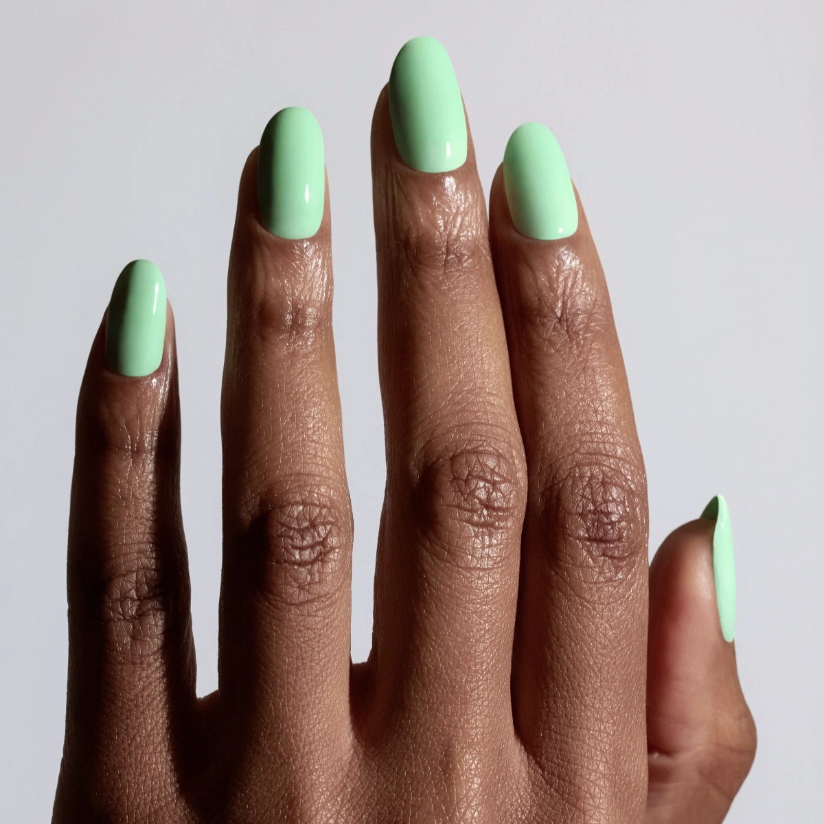 Shade Peppermint from Glossify's Endless Summer collection on a deep skin tone.