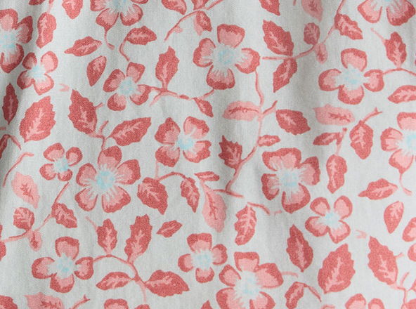 Floral pattern with pink flowers and green leaves on a light background.