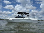 Side profile Ryan's white 2021 Malibu 23 LSV wakeboard boat on the lake photo 1