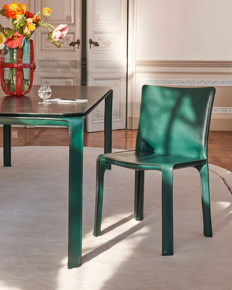 A simple Cab Chair Dining chair with a smooth, modern design.