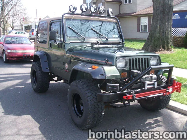 Front-three-quarter Gavan's 1995 Jeep Wrangler YJ classic seven-slot grille square headlights exterior Nathan AirChime K3 544K train horn kit featured install photo 1