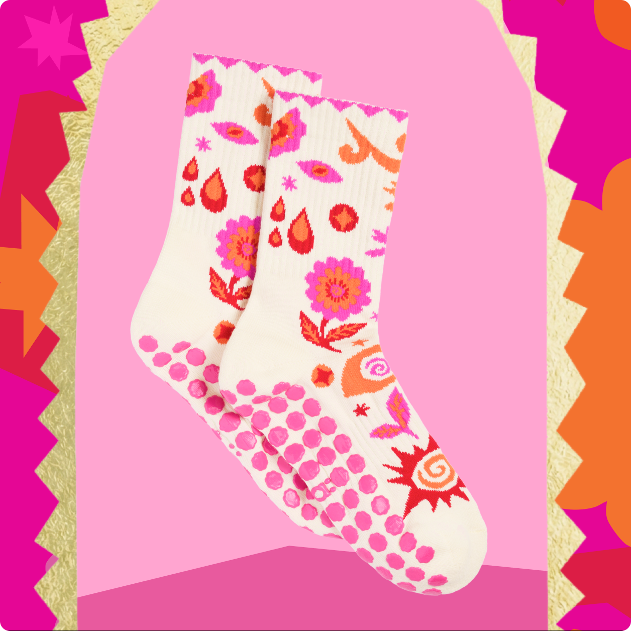 Colorful patterned socks displayed against a pink background.