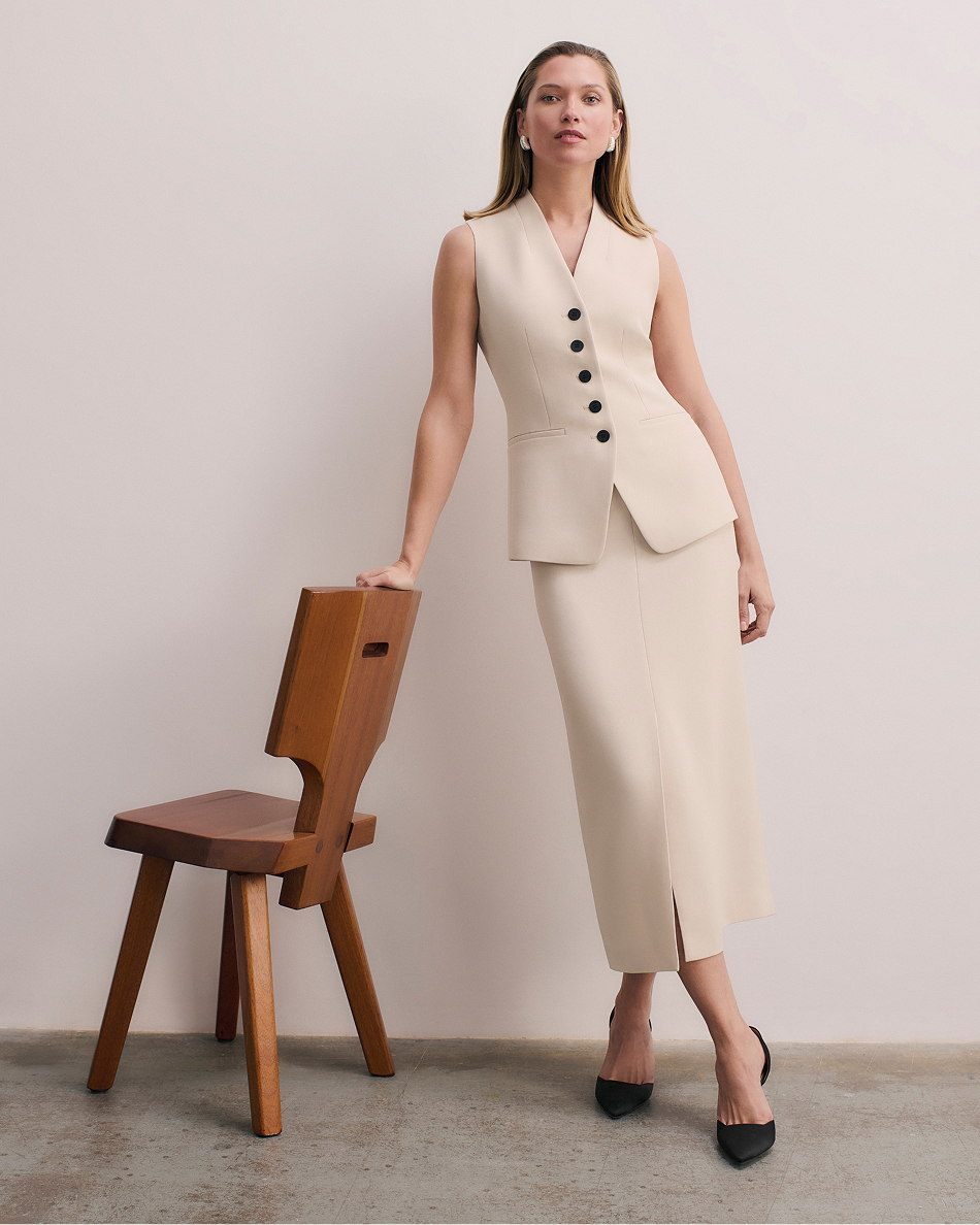 Model wearing stone Clever Crepe Hartley waistcoat and Oliena skirt