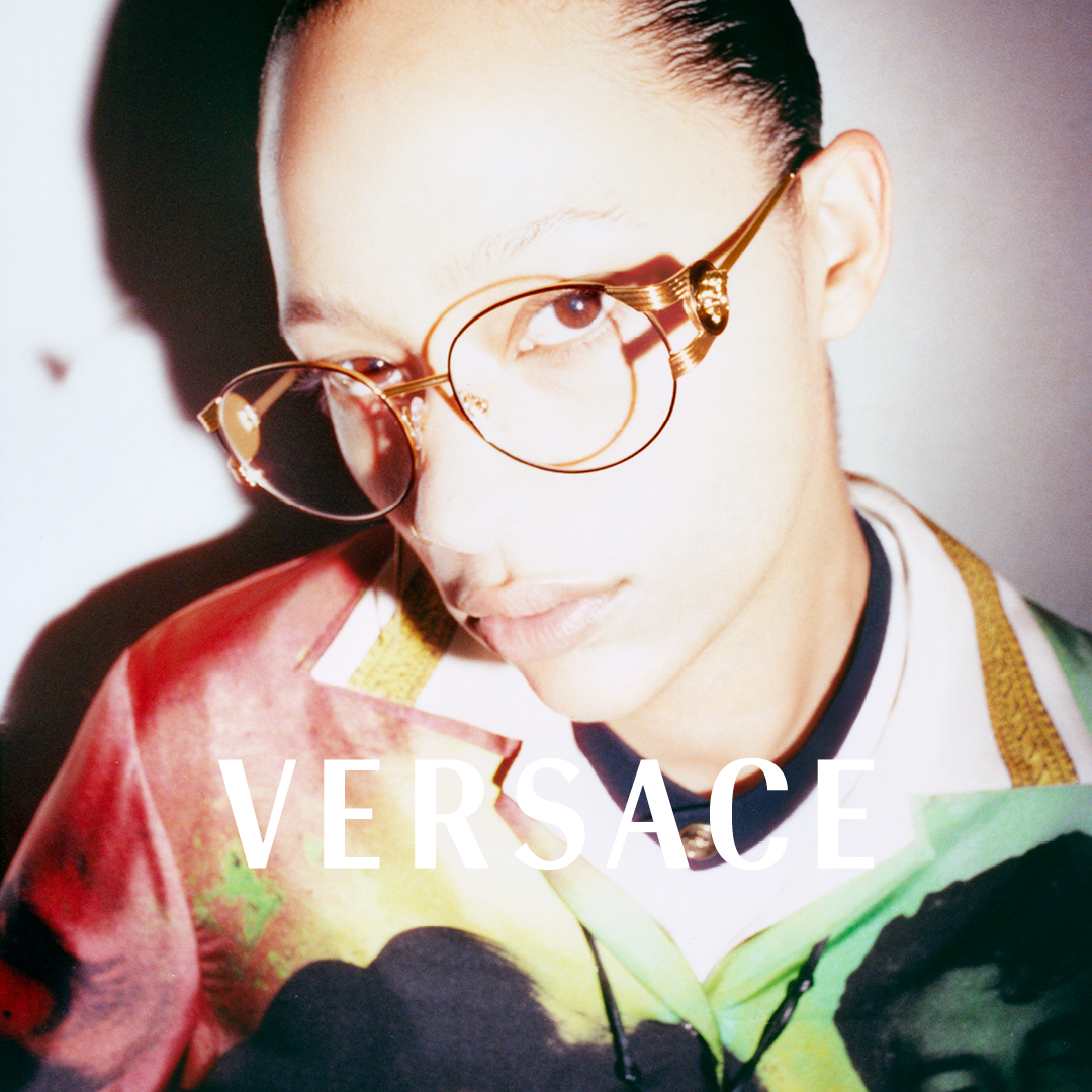 A person wearing glasses with a colorful shirt, text reads 