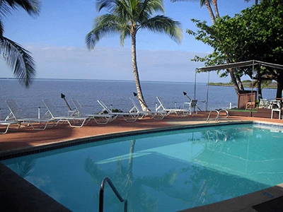 Photo of a hotel pool. You can also see the ocean.