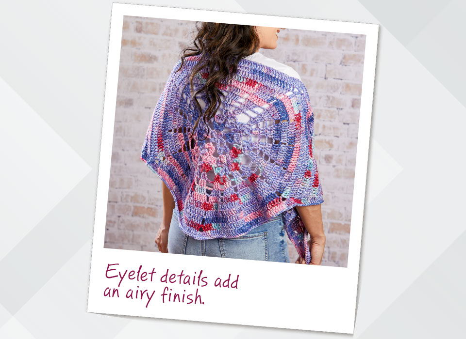 Woman wearing a colorful shawl with eyelet details add an airy finish.
