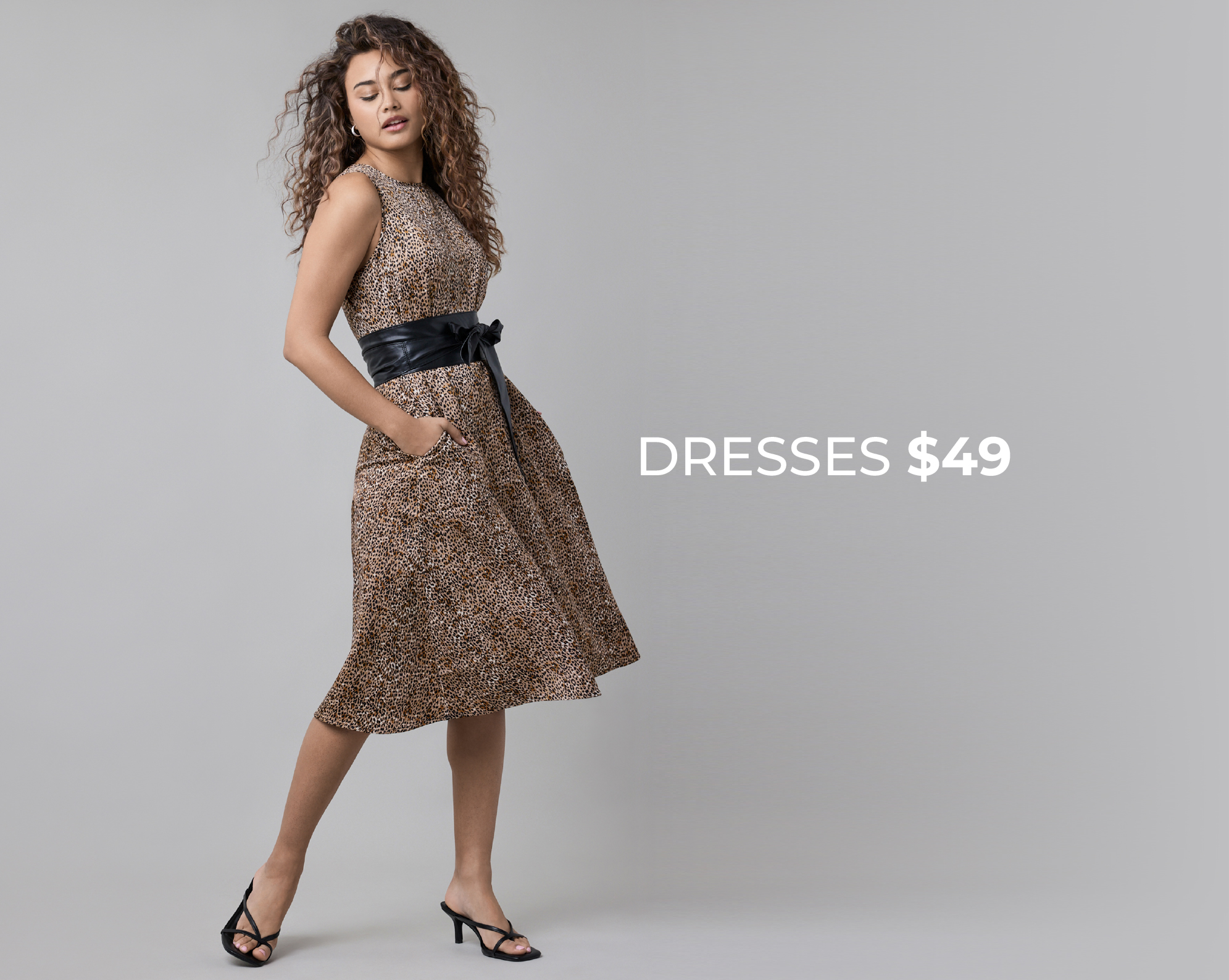 Woman in a dress with a belt, promoting dresses for $49.