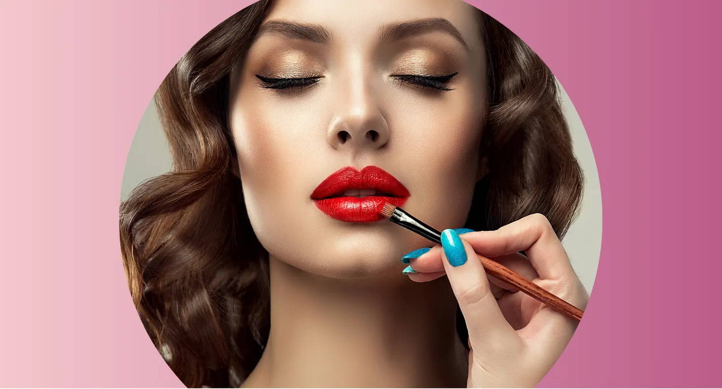 Professional makeup artist adding lip makeup to a model