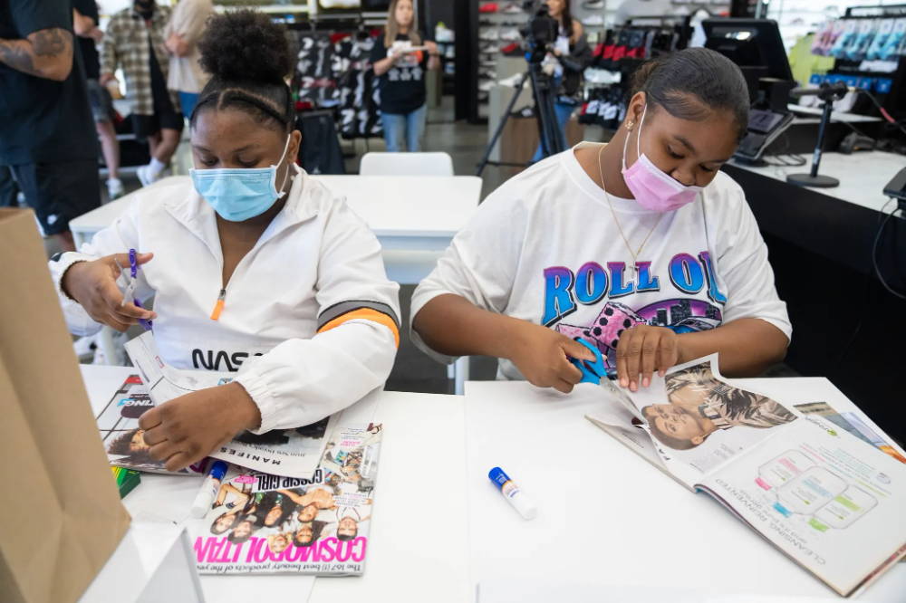 girls cutting magazines at for her event