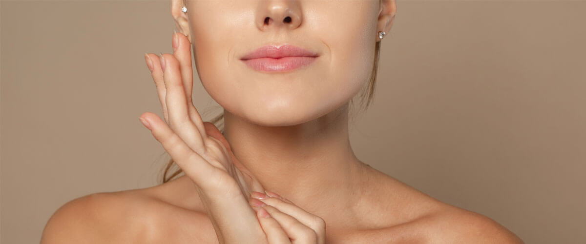 Woman touching hydrated, plump skin, illustrating collagen support for skin elasticity.