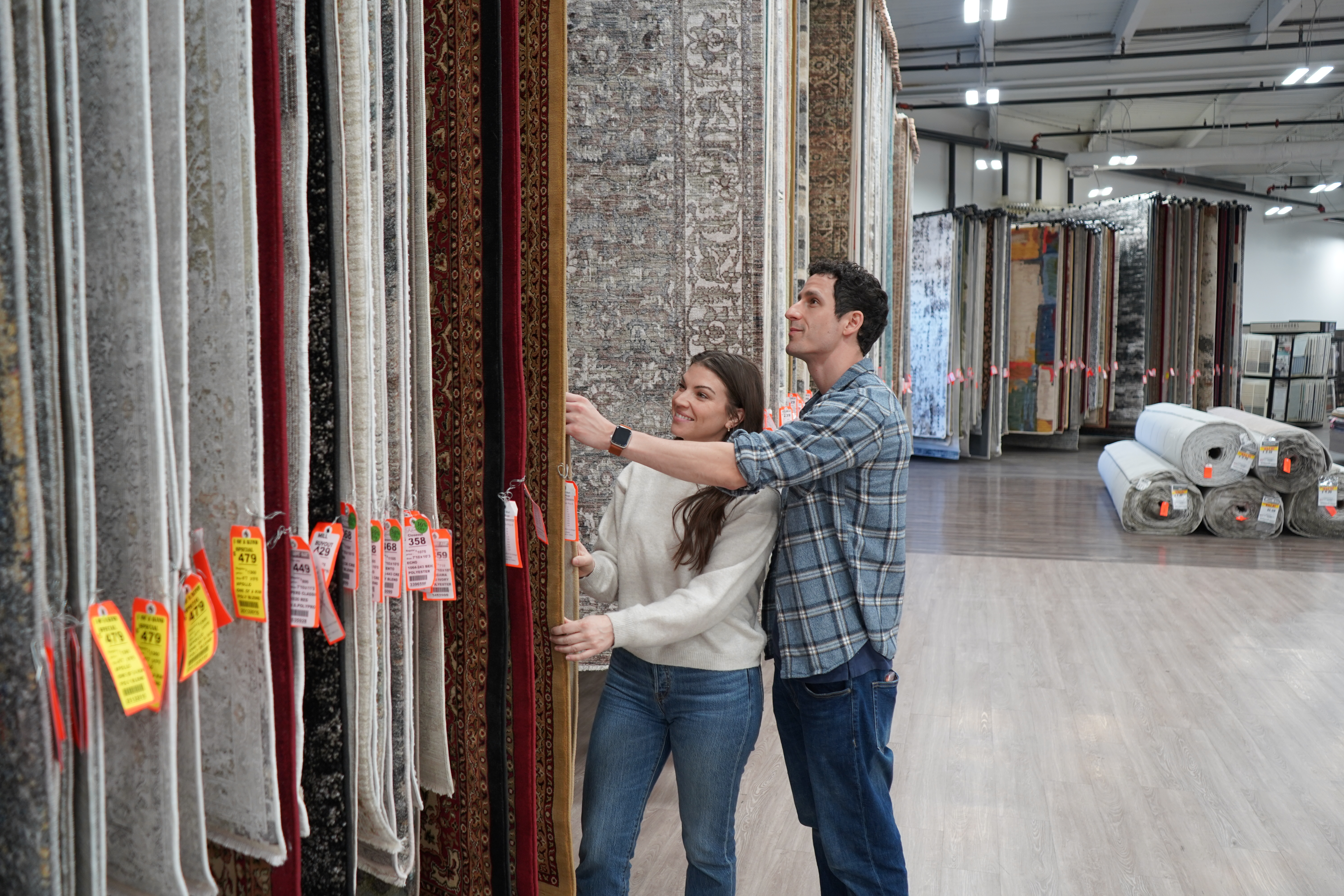 couple looking at rugs