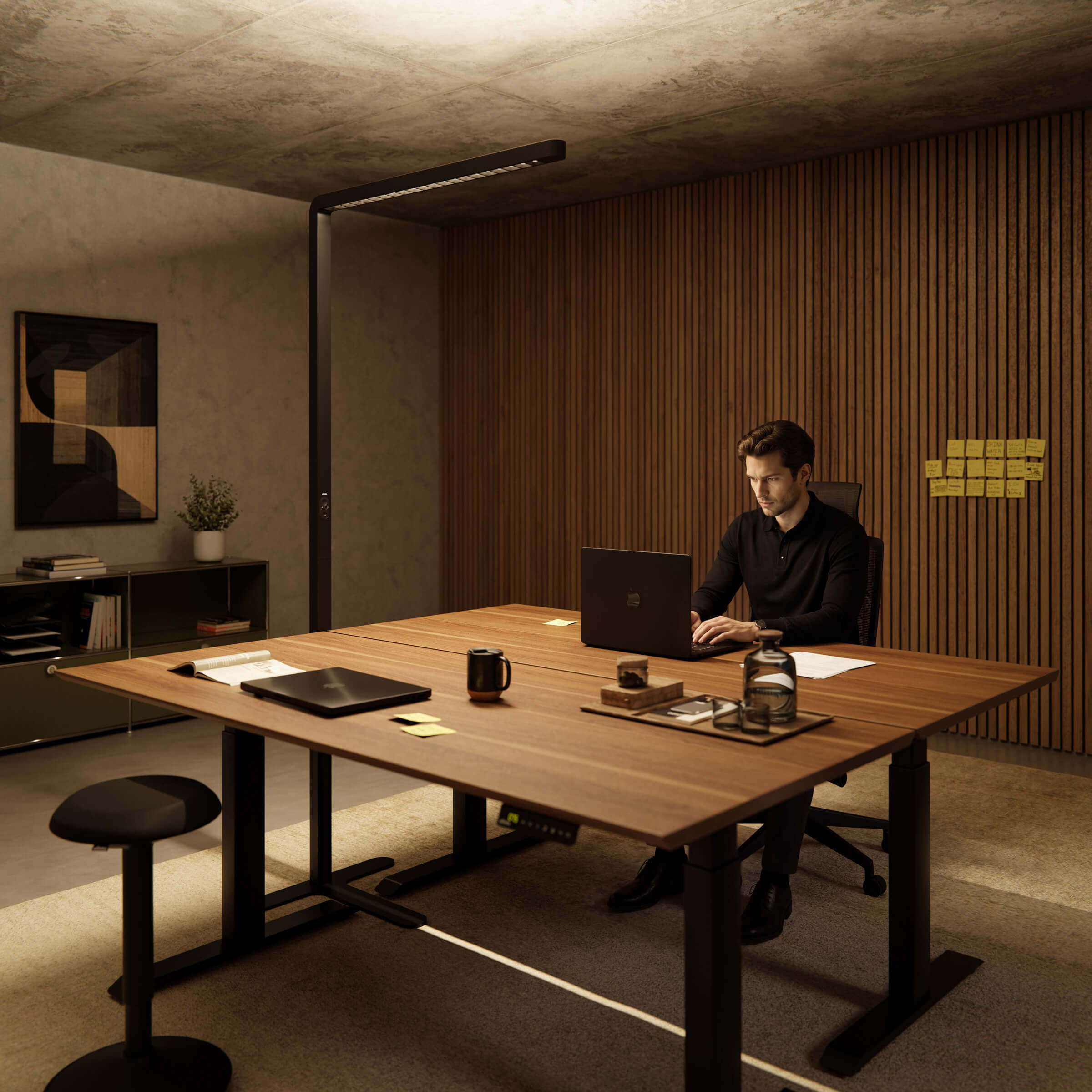 A person is working in a stylish office with a modern, bright Lumino Pro on an ofinto Elevate