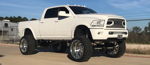 Front three-quarter lifted white John's 2014 Dodge Ram 2500 chrome wheels mud tires Shocker XL Train horn kit HornBlasters featured customer install gallery photo 1