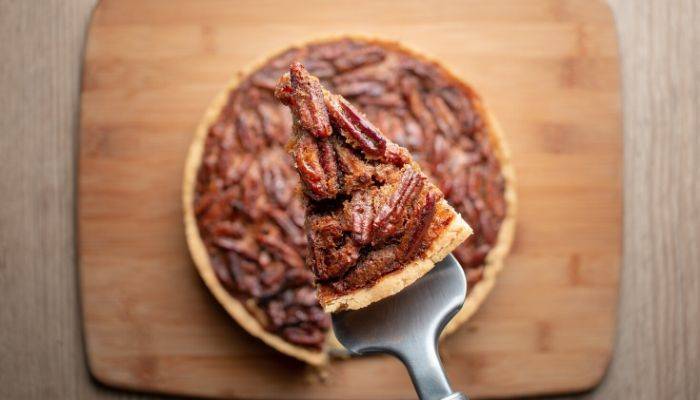 A piece of pecan pie being served