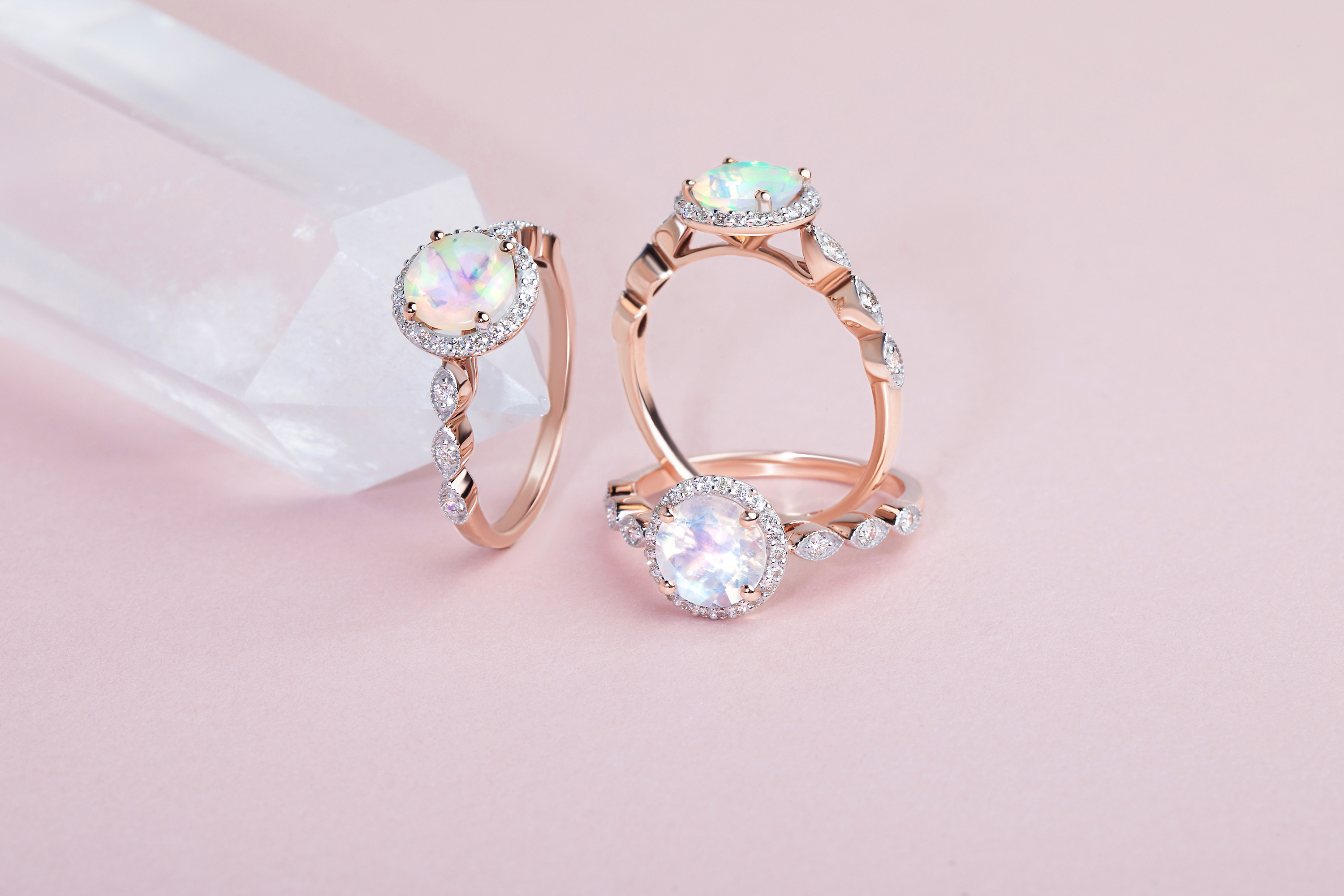Two Opal Diamond Rings - Soulmate and one Moonstone Diamond Ring - Soulmate are presented next to a raw crystal.