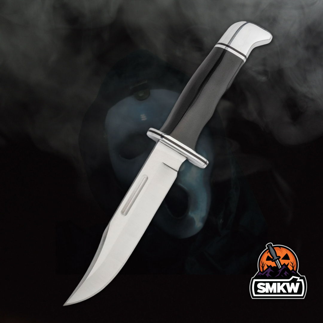 A knife with a black handle and silver accents on a smoky background.