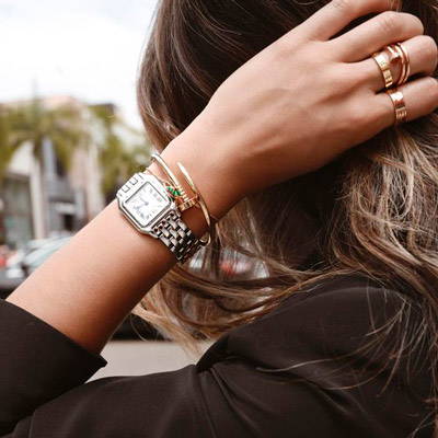 Woman styling her bracelet with a watch