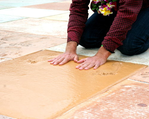 a person's hands on a wooden surface