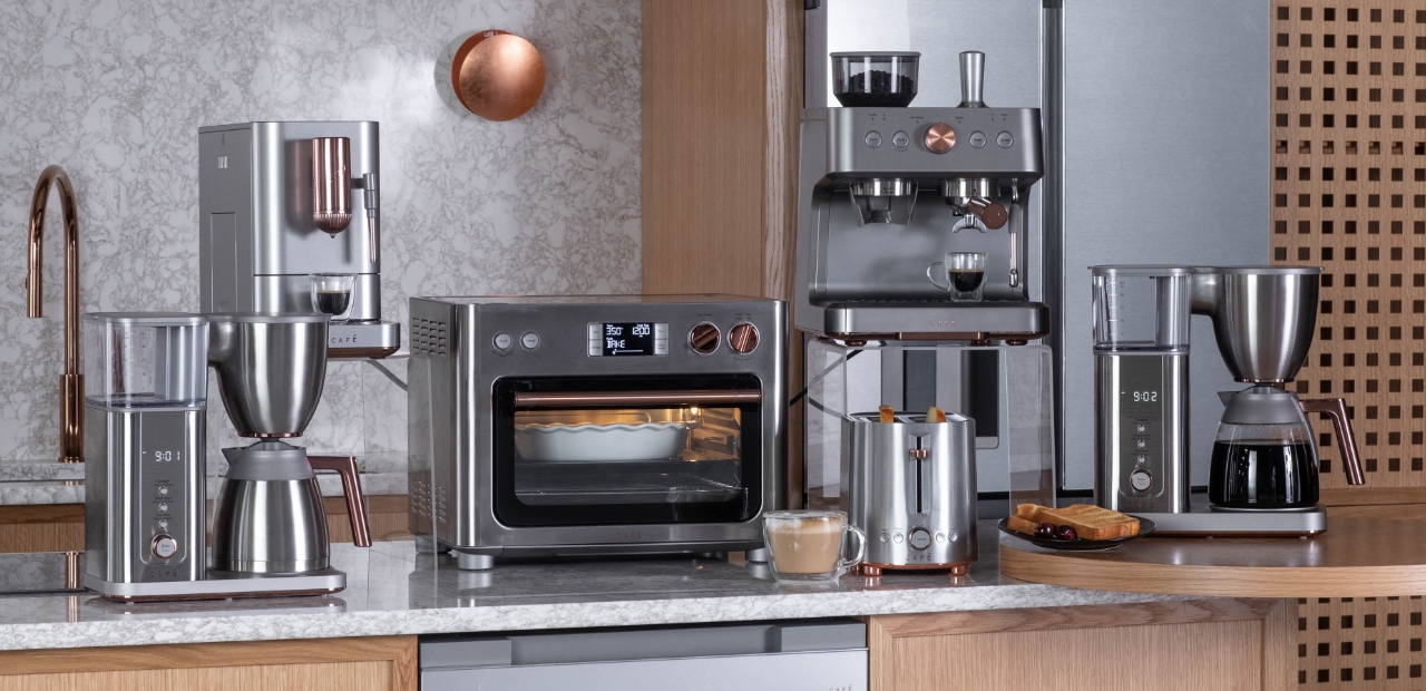 A collection of stainless steel countertop appliances on a kitchen countertop.