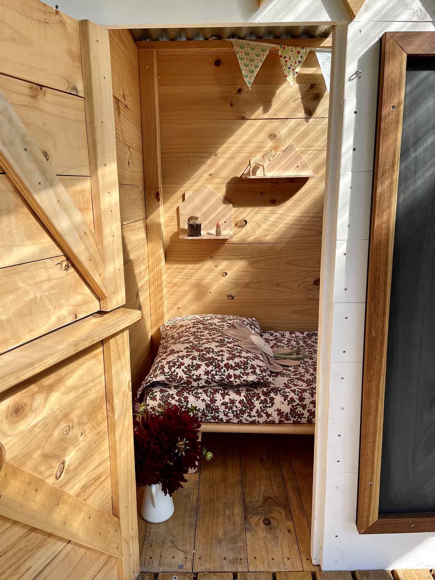 A bed for outdoor sleep over sin their wooden cubby house