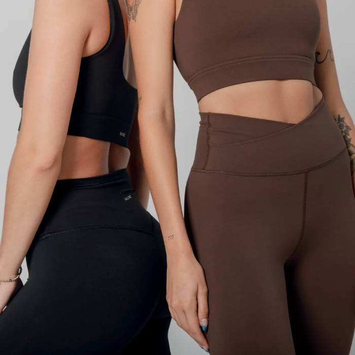 female models wearing matching black and brown sacre fitness sets