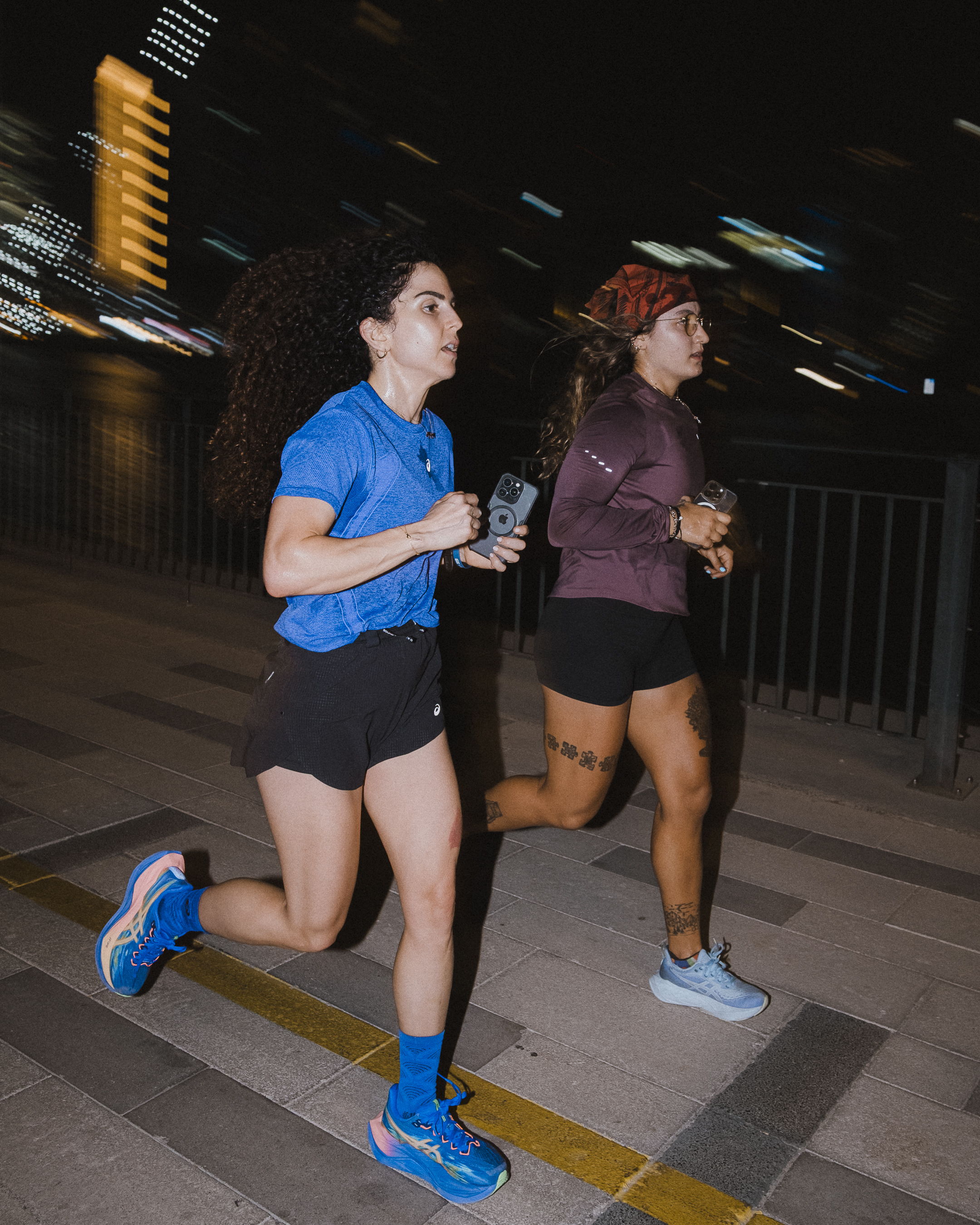 Runners enjoying a community run along the Dubai Canal during Global Running Day with ASICS and FRAME RUN CLUB in Dubai Design District.