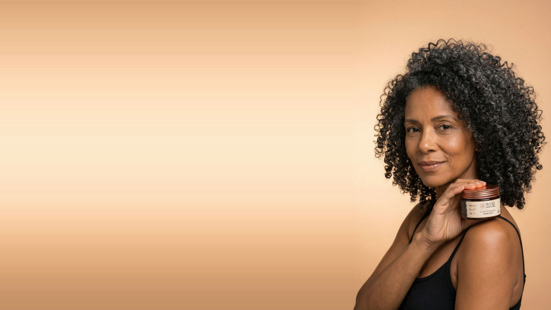 Afro-Latin Woman Holding Wuli Curl Cream