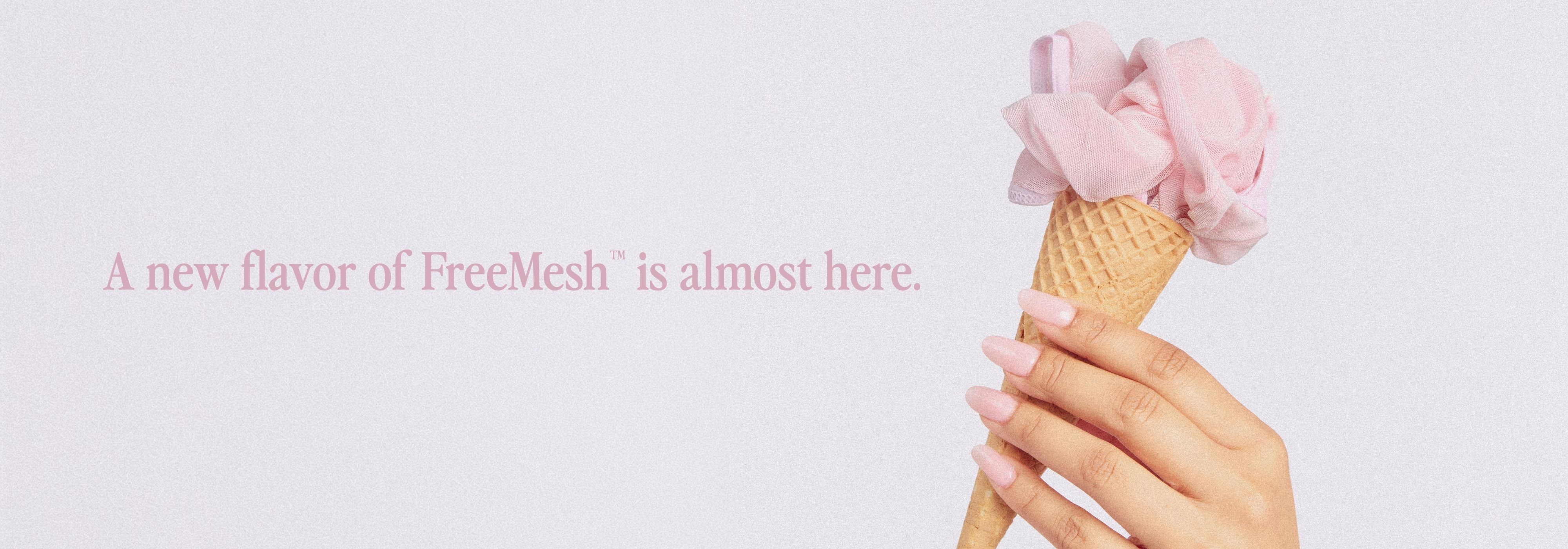 A hand holding an ice cream cone with pink ice cream.