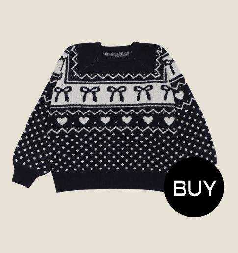 Black and white patterned sweater with bows and hearts, featuring a 